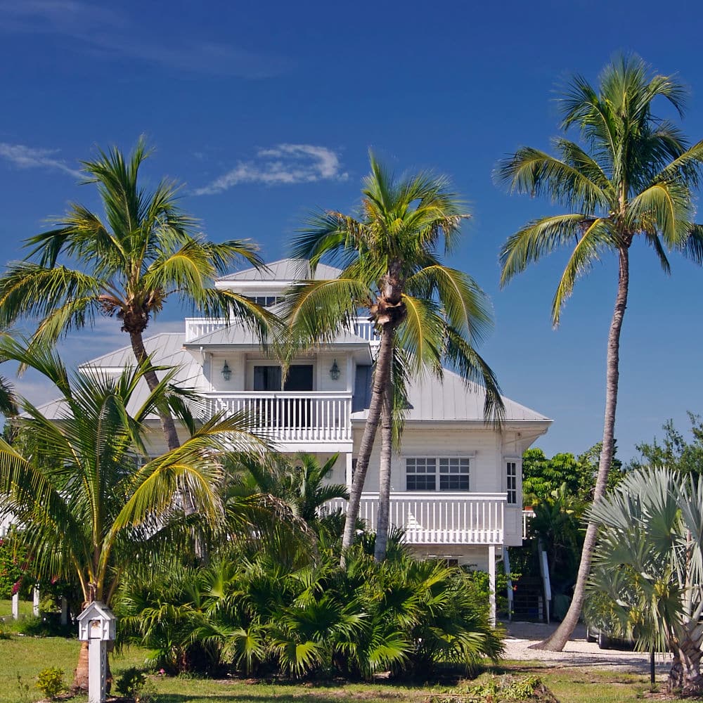 Tropical beach setting with a beautiful Florida style home